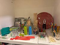 Shelf with cocktail picks, napkins, glasses, silicone molds, ice sticks, serving tray, nutcracker