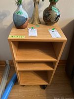 Full view of cabinet with open shelves and casters