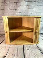 Cabinet with doors open showing interior shelf