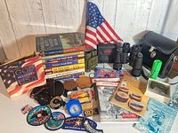Overall lot showing books, patches, binoculars, compasses, flag and accessories
