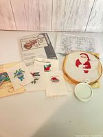 Overview of all cross stitch materials including hoops, stitched panels, pattern sheets and floss