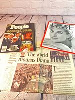 Group shot of People magazine, Time magazine, and newspaper front page