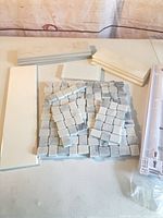 Assorted tiles and installation tool arranged on table