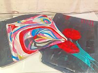 Both scarf ponchos folded side by side showing overall patterns