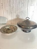 Tureen with lid beside scalloped serving dish, showing size and tarnish
