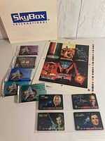 Group shot with eight sealed card packs, proof sheet, phone cards, SkyBox bag