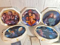 Five Star Trek decorative plates in foam boxes with COAs displayed