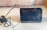 Front view of Technicolor TCA203T with attached stand and power adapter
