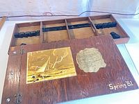 Box open showing exterior lid with sailboat plate, paper plaque and Spring ’81 inscription