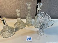 Group shot of four decanters and one pitcher