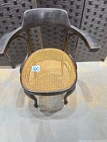 Front view of black bentwood armchair with cane seat