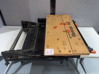 Top view of folded Workmate 400 showing hardboard surface, bench dogs, ruler