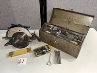 Group shot showing circular saw, toolbox with contents, rule, screwdriver set, chisels and accessories