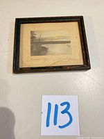 Full view of framed seascape print with number tag