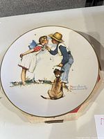 Boy and girl with dog Spring scene plate showing gold rim and artwork detail