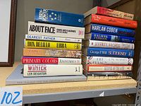 Both stacks of hardcovers showing spines for title verification