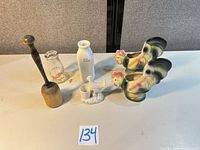All six items displayed: two rooster planters, Woodside Dairy bottle, white ceramic bottle, small rooster toothpick holder, wooden mallet