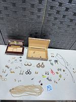 Overview of jewelry boxes and spread of costume jewelry on table
