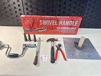 All items laid out: boxed swivel handle kit, brackets, brace, file, hammer, punch, hawk