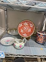 Group view on shelf showing plate, jar, saucer, creamer, stand