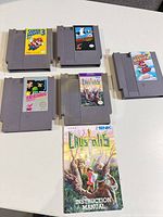 Five NES cartridges and Crystalis manual layout