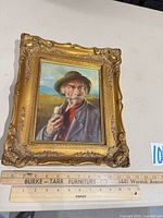 Full view of framed portrait with ruler for scale