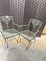 Both wrought iron chairs side by side showing overall design and condition