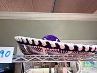 Side profile of purple velvet sombrero on shelf