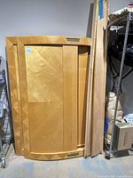 Disassembled headboard panel and side rails leaning against wall
