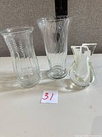Front view of all three clear glass vases lined up