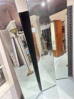 Mirrored side of three separated panels showing hinged edges and black frame