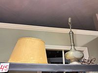 Lamp base and detached fabric shade on shelf