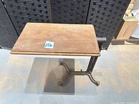 Full view of stand showing wood top and cast iron base