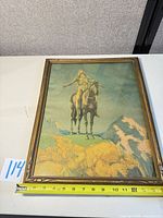 Full view of framed print with tape measure for width reference