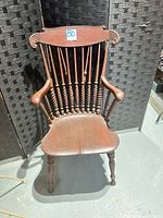 Front view of Windsor armchair showing spindle back, armrests, seat, legs