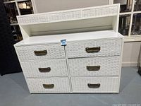 Front view showing dresser, six wicker-front drawers, brass pulls, removable hutch shelf