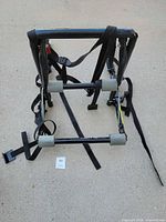 Overall folded bike carrier showing frame, foam pads, straps