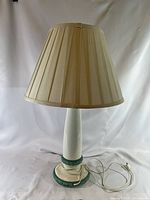 Full view of ceramic lamp with shade and cord