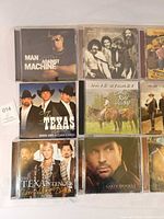Nine jewel case CD fronts laid out in 3×3 grid