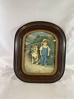 Front view of framed child and dog print