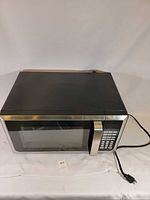 Top and front view of microwave showing overall form and power cord