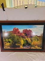 Front view of large framed landscape print showing image, matte, and wood frame