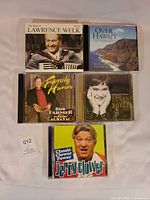 Front view of all five CD jewel cases showing cover art