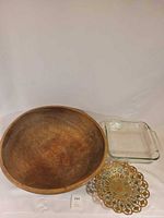 All three items: wooden bowl, glass casserole, metal dish