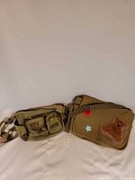 Two olive/khaki canvas bags side by side showing overall style and size
