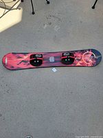 Full view of snowboard showing graphics and bindings