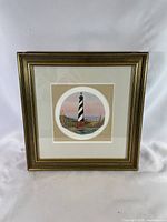 Full view of framed lighthouse print showing matting and frame style
