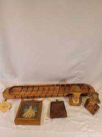 Group shot: wooden tray, framed straw art, two busts, leather wristlet