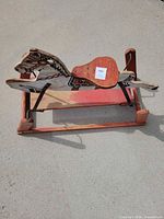 Full view of wooden rocking horse on red spring base