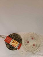 Waffle pan with tag and glass cake plate overview